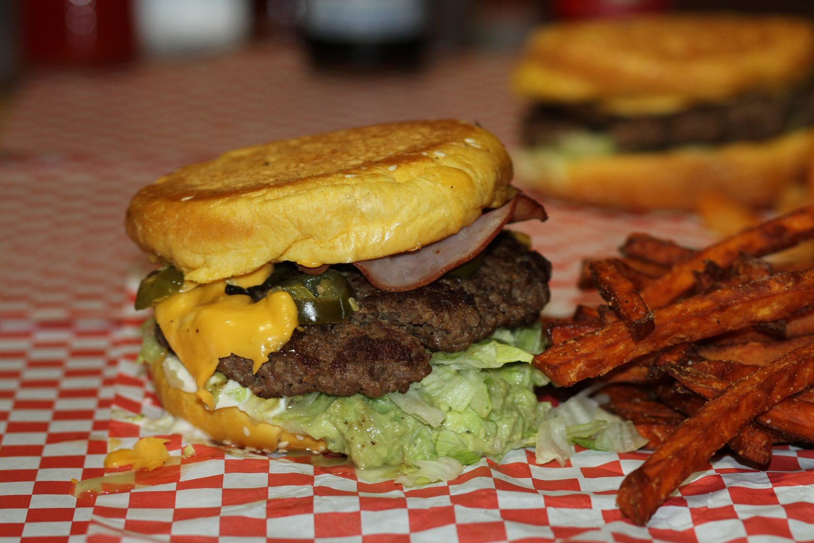 Hippo Burgers cheeseburger paired with a side of sweet potato fries